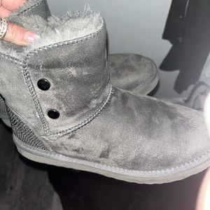 grey ugg-like boots with sparkly rinestones on the back